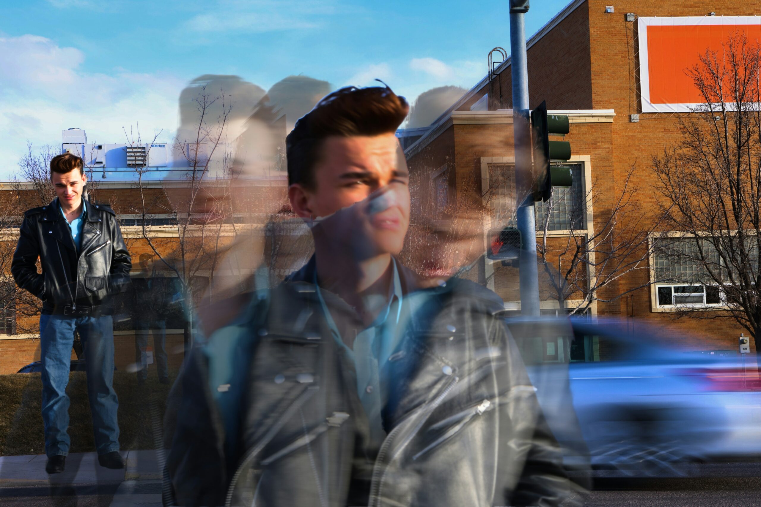 Blurred image of a man walking down the street.