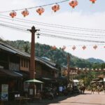 Street with lanterns and shops in a sunny day.