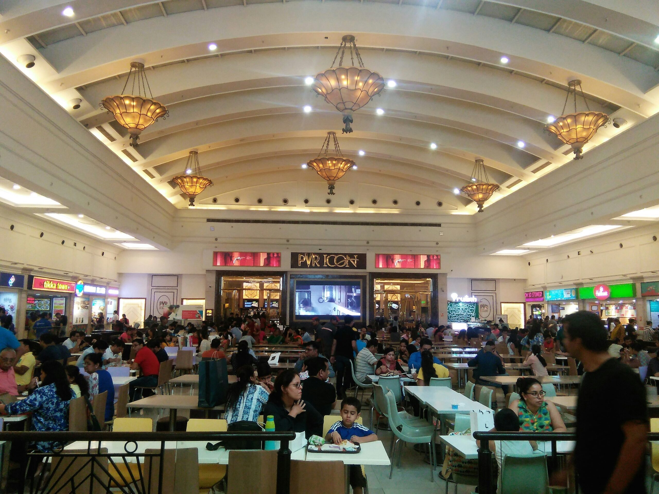 a large group of people sitting at tables in a restaurant