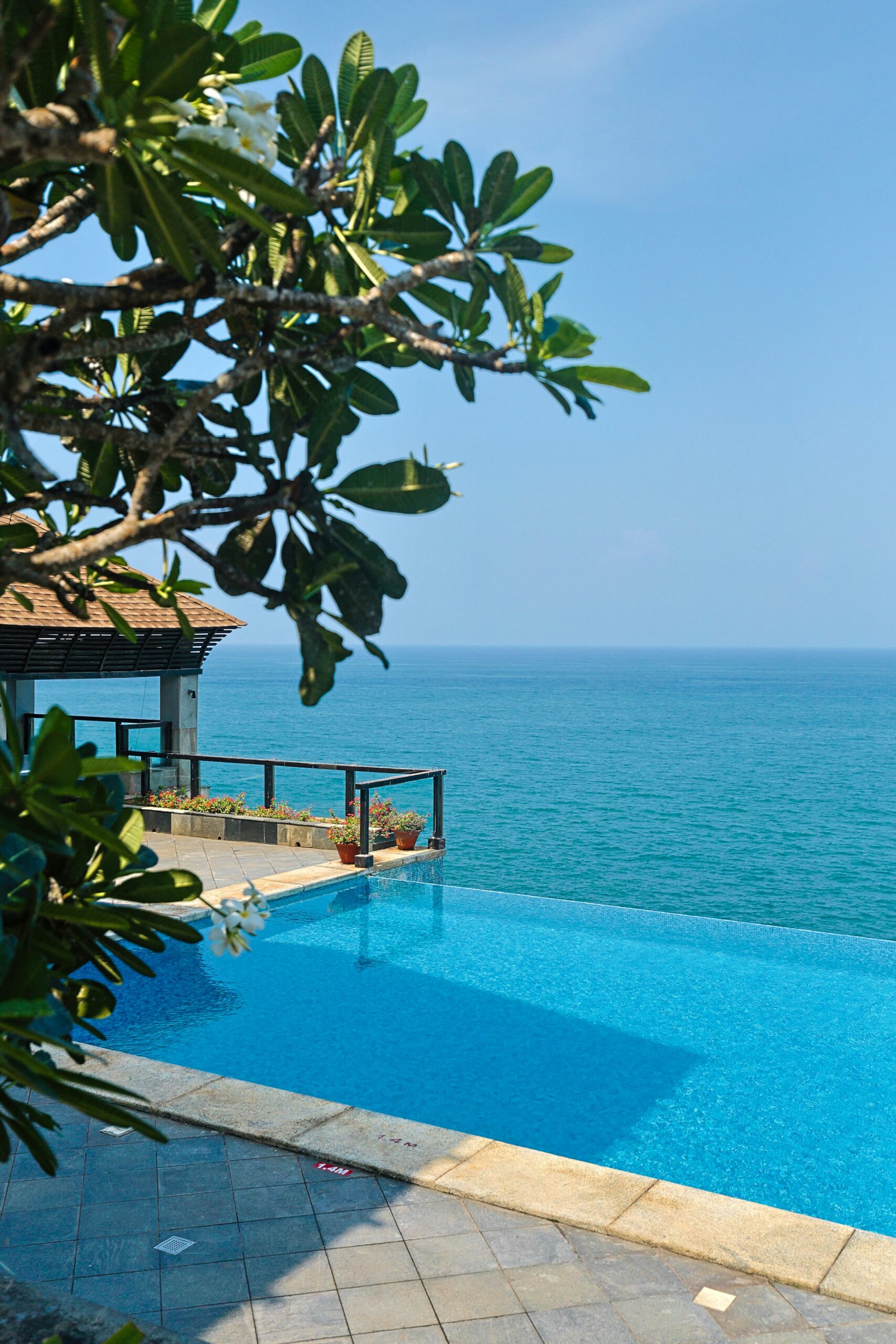 a large swimming pool with a view of the ocean