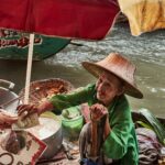 a woman in a straw hat is serving food to another woman