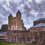 brown brick building under cloudy sky